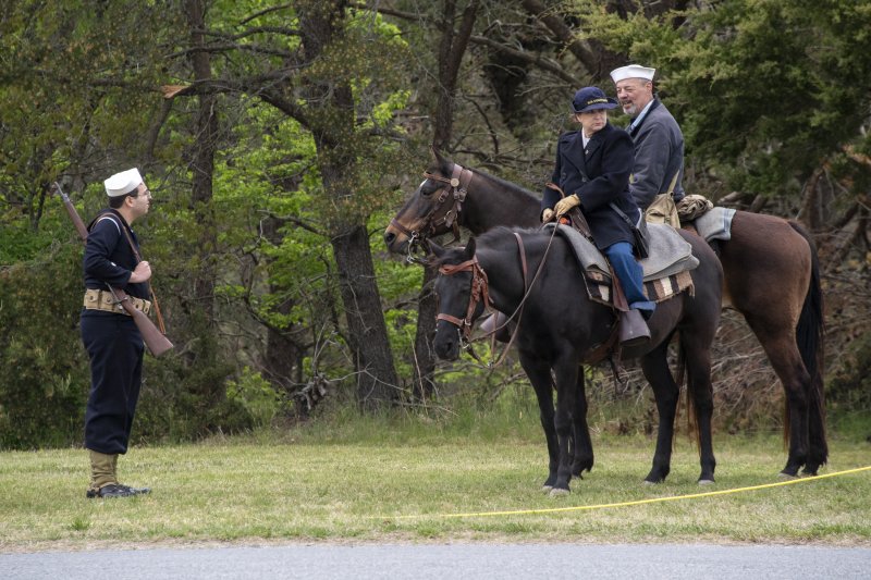 Anthony Manzi, left, converses with David Miller on Pearl and Sheila Gladfelter on Dancer at Fort Miles Defense Day.